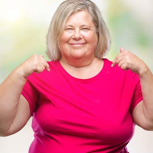 Senior plus size caucasian woman over isolated background looking confident with smile on face, pointing oneself with fingers proud and happy. woman focusing on herself